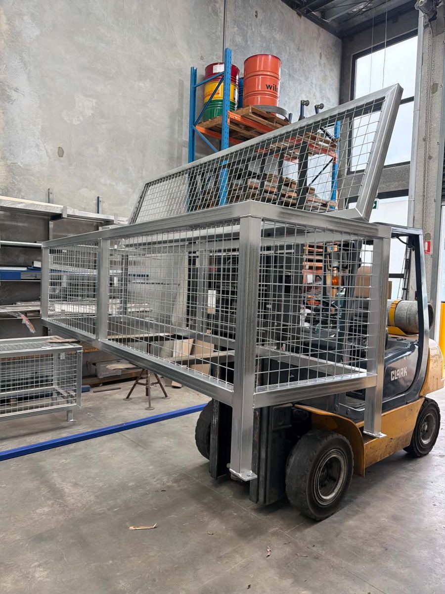 Large custom galvanised steel cage on a forklift in the EcoScape fabrication facility